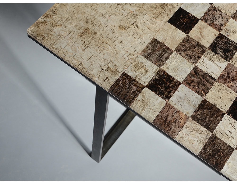Phellem Chess Table features a checkered surface crafted from natural cork textures in light and dark tones. The tactile finish and refined frame turn a classic game board into a striking modern table.