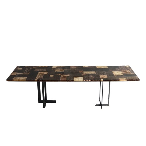 Phellem Dining Table presents a mosaic cork top in earthy shades, resting on slender geometric legs. Its bold pattern and natural texture give it a refined and contemporary character.
