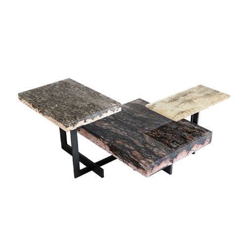 Phellem Low Table presents stepped cork surfaces in natural tones, set on sleek black legs. Its layered design highlights organic textures while offering a bold architectural presence.