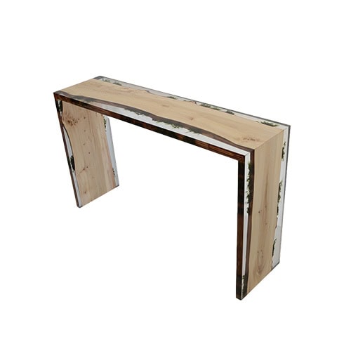 Trail Console blends natural wood panels with crystal clear resin in a sleek, angular form. Its minimalist structure highlights organic textures while maintaining a modern aesthetic.