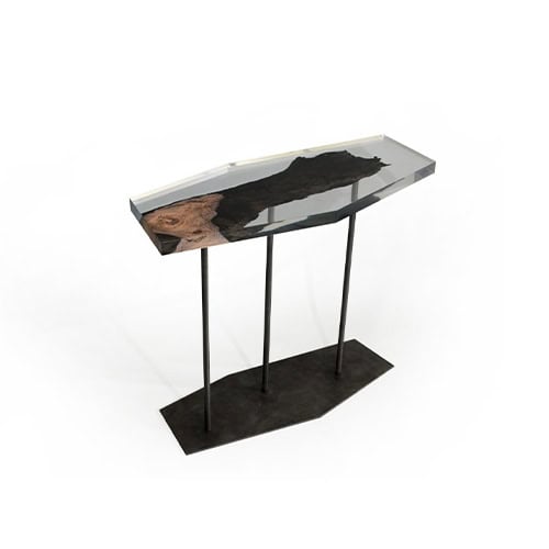 Wetland Fragment Console presents a resin-encased wood fragment on slim black legs. Its angular top and organic detail create a refined balance of modern and natural design.