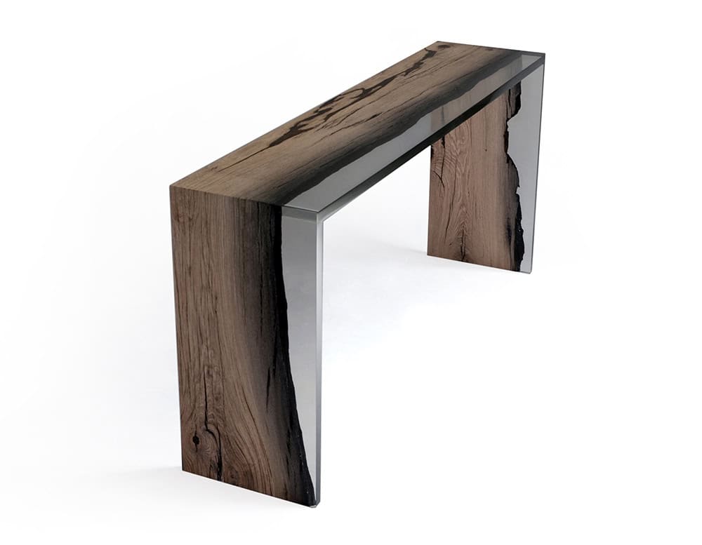 Wetland One Side Console combines dark-toned wood with clear resin in a bold geometric frame. Its asymmetry and natural grain bring organic depth to a sleek modern silhouette.