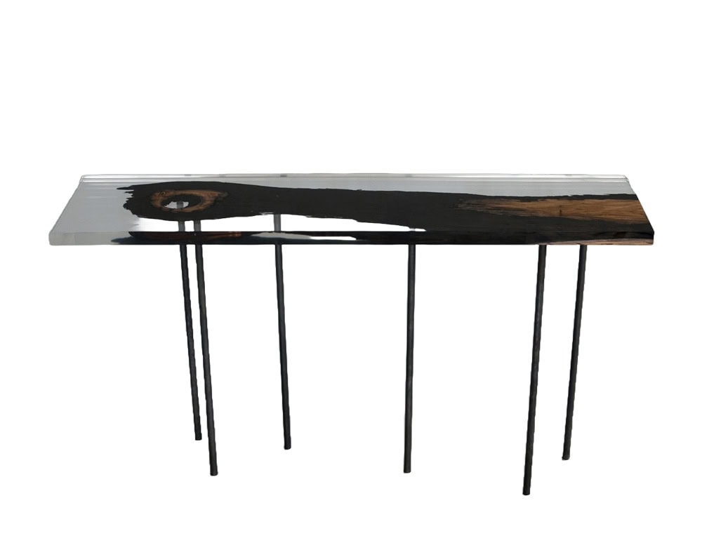 Wetland Relic Console showcases preserved dark timber embedded in resin, elevated by slim black legs. A refined blend of natural character and sleek minimalism.