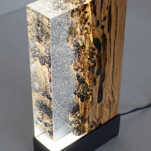 piece made of natural wood base coated in alcarol resin in a golden and transparent tone