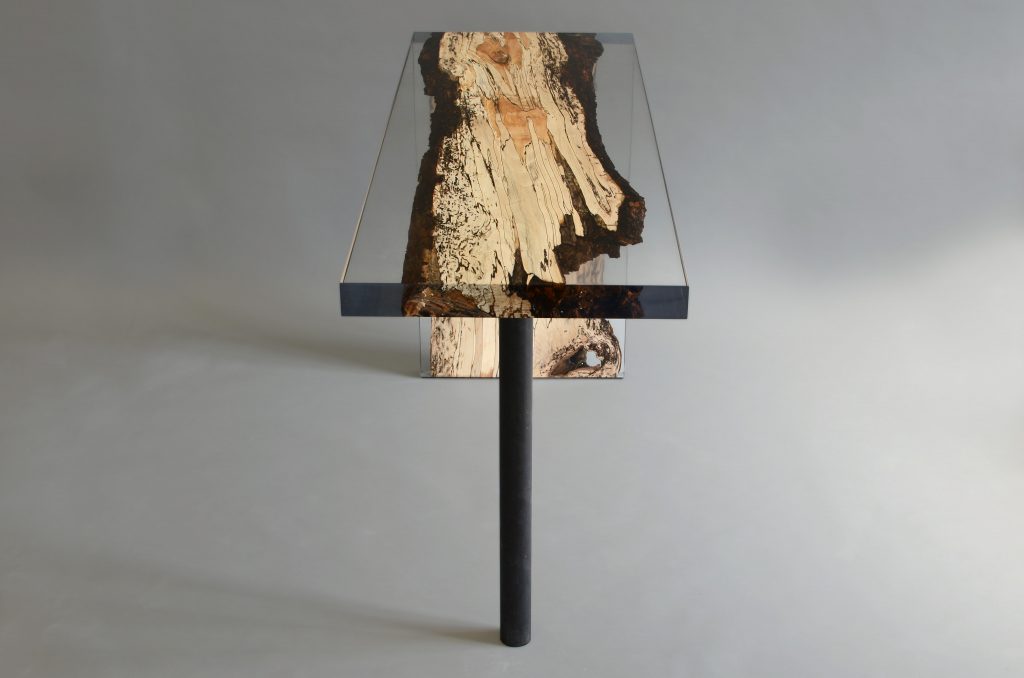 Fungi Console with an elongated, rectangular shape, made of wood with a natural finish and featuring a transparent resin inlay, set against a white background.