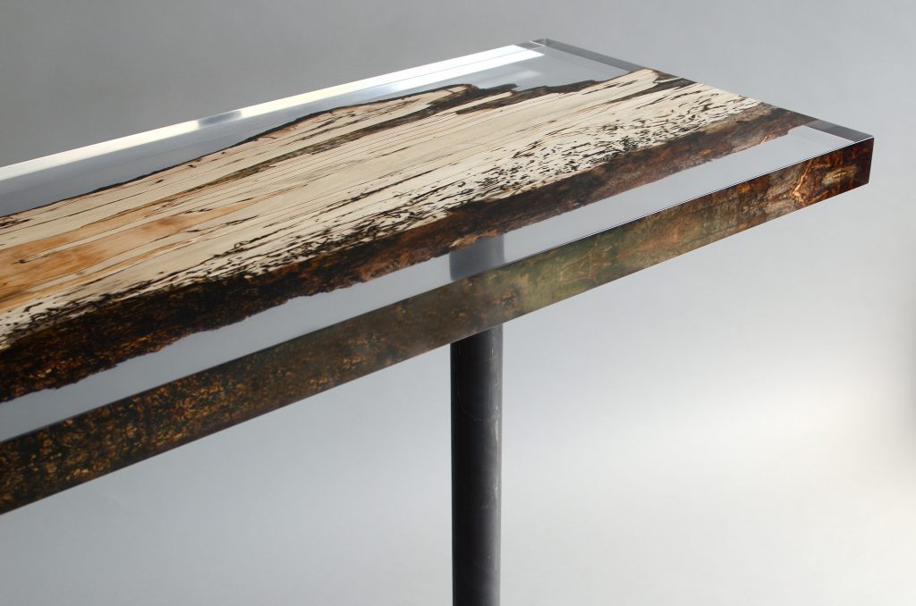 Fungi Console with an elongated, rectangular shape, made of wood with a natural finish and featuring a transparent resin inlay, set against a white background.