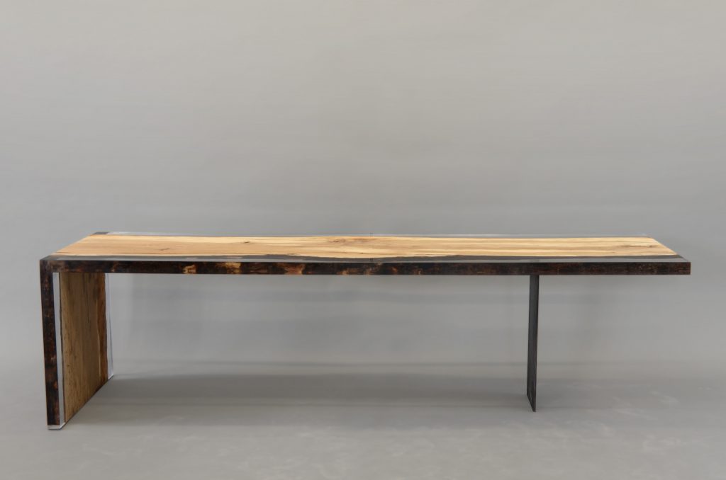 Fungi Dining Table with an organic, rectangular shape, made of wood with a natural finish and featuring a transparent resin inlay, set against a gray background.