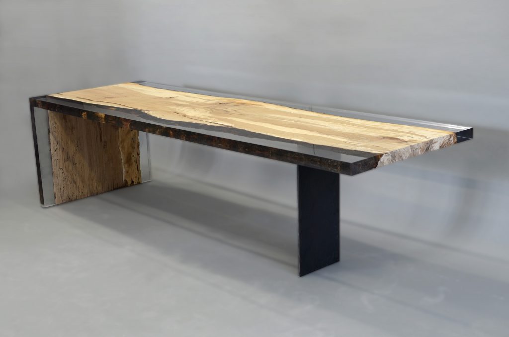 Fungi Dining Table with an organic, rectangular shape, made of wood with a natural finish and featuring a transparent resin inlay, set against a gray background.