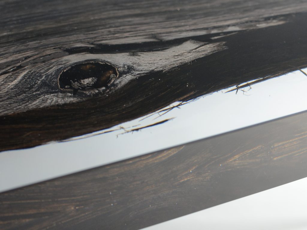 Closeup of Peatland Bench/Low Table with a rectangular shape, featuring a natural wood finish and clean lines, set against a white background.