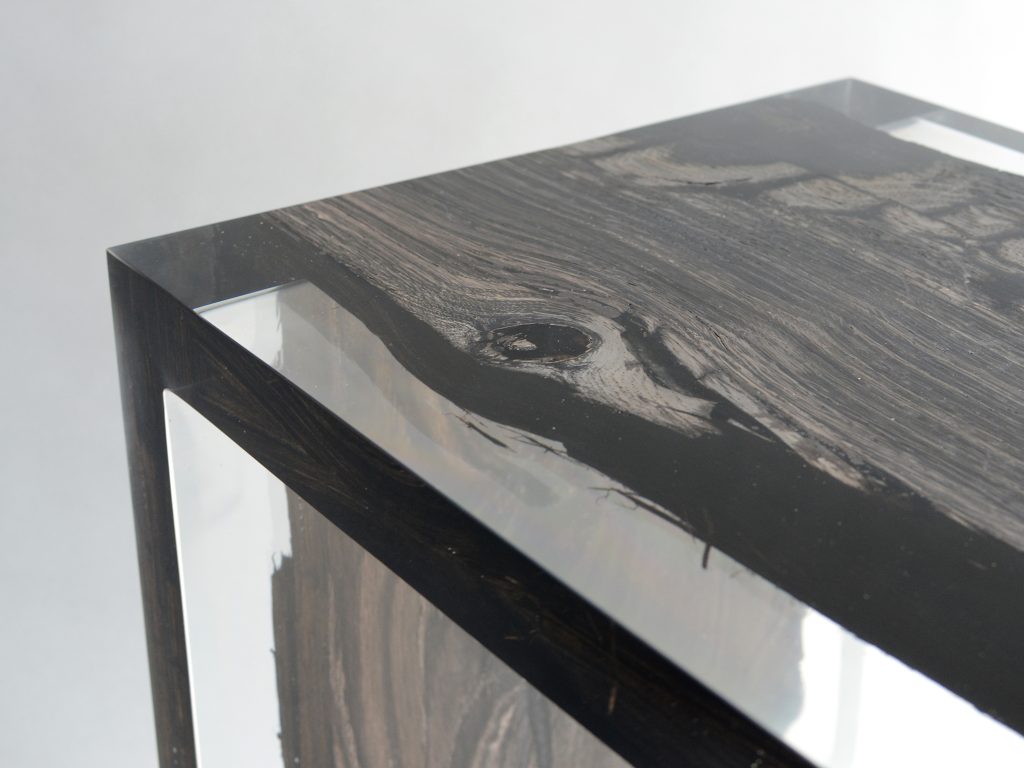 Closeup of Peatland Bench/Low Table with a rectangular shape, featuring a natural wood finish and clean lines, set against a white background.