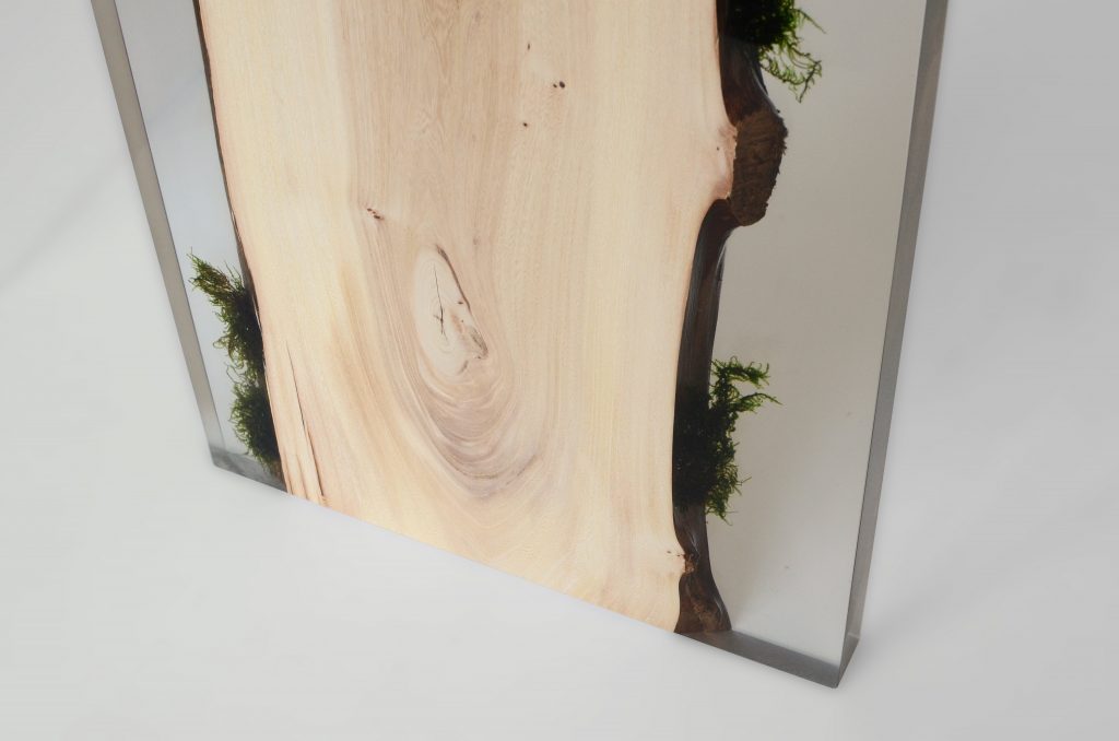 table made with alcarol resin based on a tree and light walnut wood on a gray background