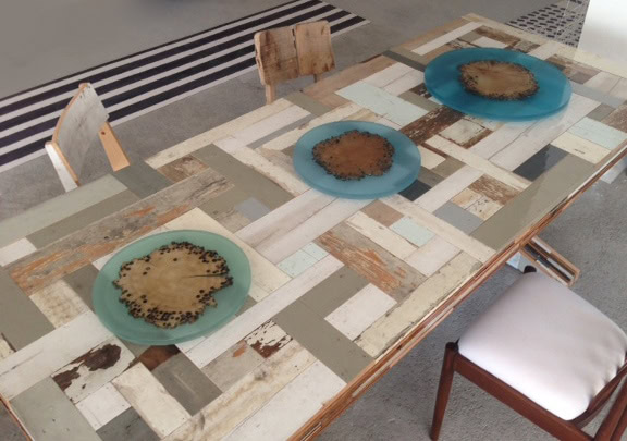 three plates made of transparent polycarbonate and glass in a blue tone in a room