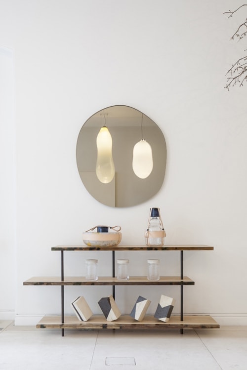 three-story table made of natural wood, resin and steel in a light brown tone