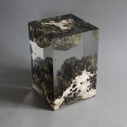 Floating Karst Stool/Side Table with a geometric design, made of natural stone with a transparent resin inlay, set against a gray background.