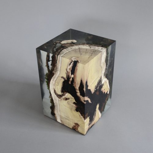 stool made of natural wood base covered in transparent resin in the shape of a cube on a gray background