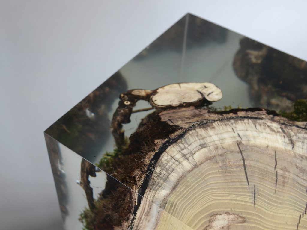 stool made of natural wood base covered in transparent resin in the shape of a cube