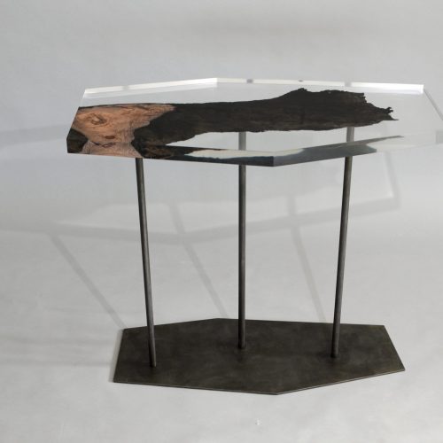 table made of resin and natural wood in the shape of a hexagon resting on a base of steel legs