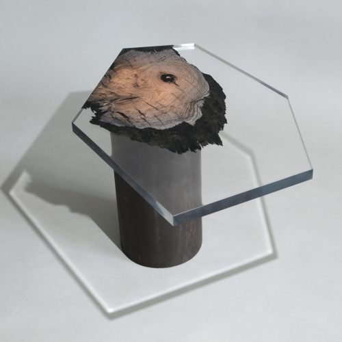 side table made of a brown wooden log and thick transparent glass top in the shape of a hexagon