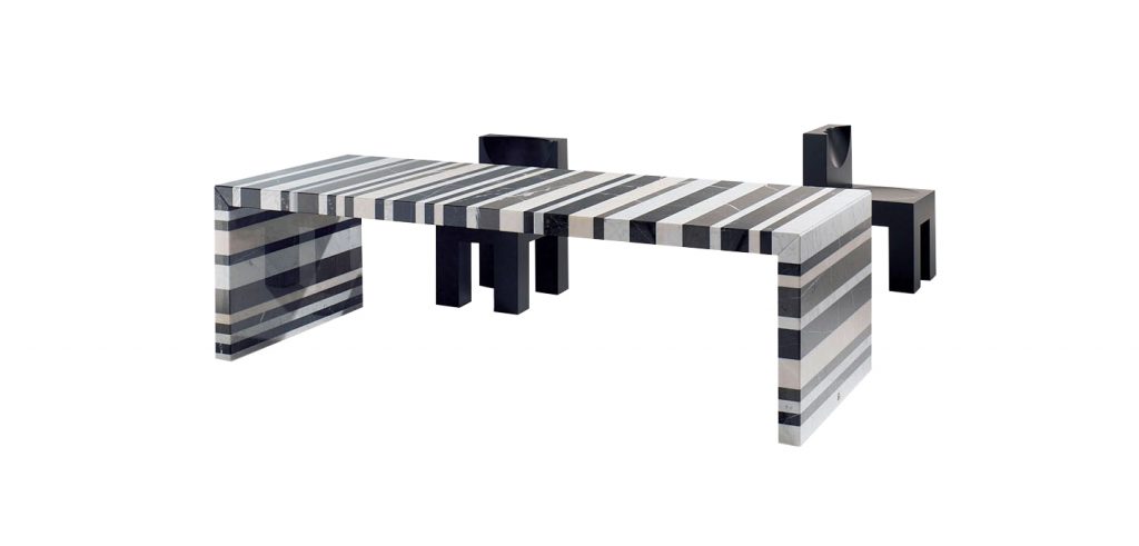 dining table made of stone and steel base in shades of black with white in zebra lines on a white background