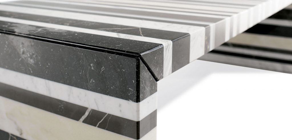 dining table made of stone and steel base in shades of black with white in zebra lines