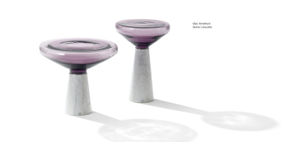 side table made of stone and glass base in a shade of pink with white on a white background