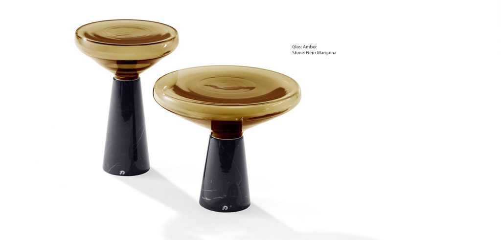 side table made of stone and glass base in a shade of yellow with black on a white background