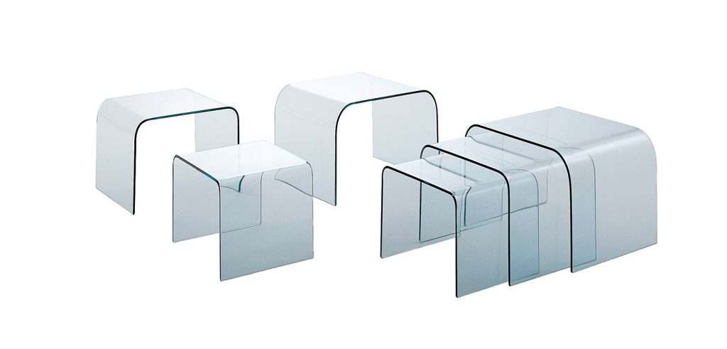 set of three coffee tables made of transparent or lacquered glass base on a white background
