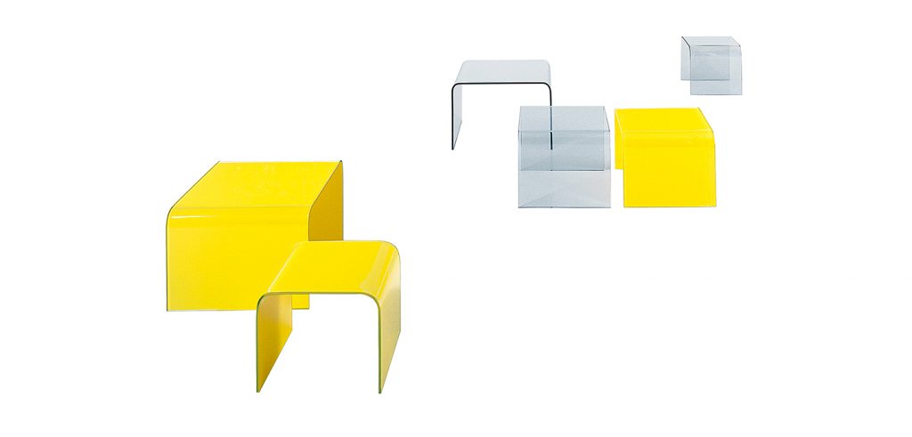 line of side tables made of glass throughout its structure in a yellow and transparent tone