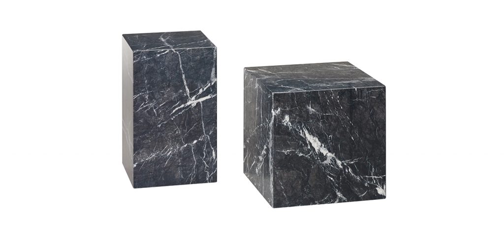 two small sculptures made on a natural stone base in the shape of a cube in shades of black and white