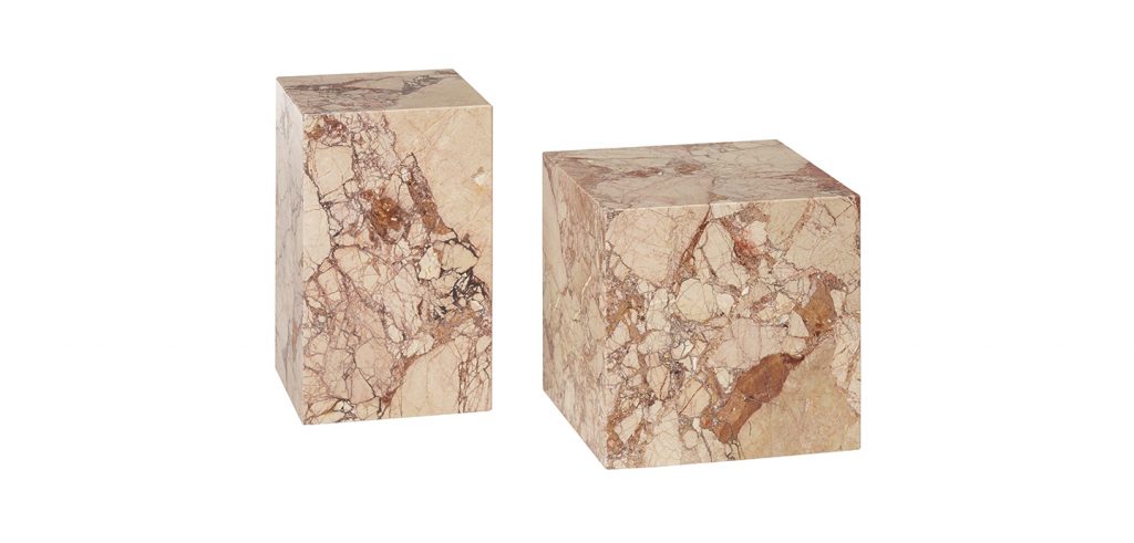 two small sculptures made on a natural stone base in the shape of a cube in shades of orange and white