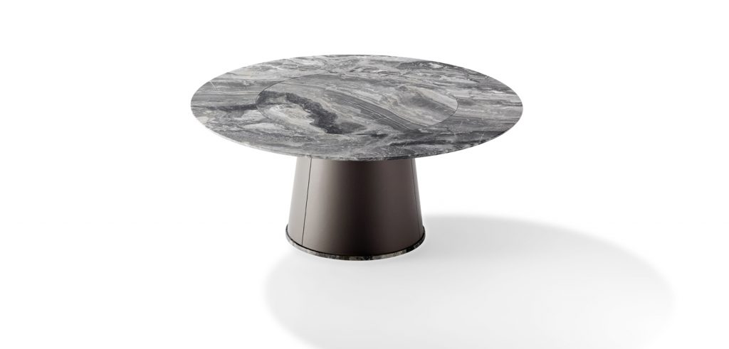 round dining table made of natural stone in a black with gray color tone on a cone-shaped rotating base