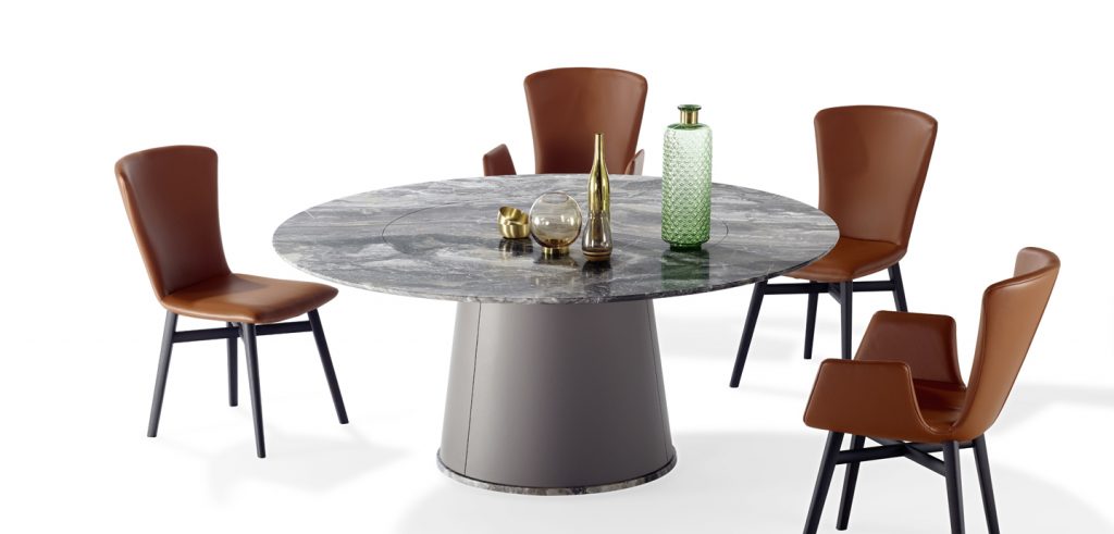 round dining table made of natural stone in a black with gray color tone on a cone-shaped rotating base with chairs around