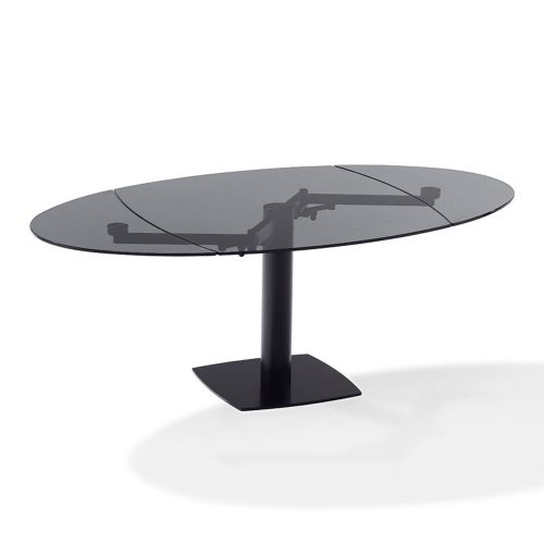 extendable dining table made of black glass with two leaves on a black steel base on a white background