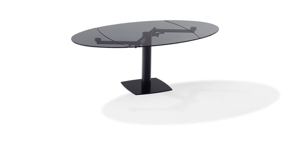 extendable dining table made of black glass with two leaves on a black steel base on a white background