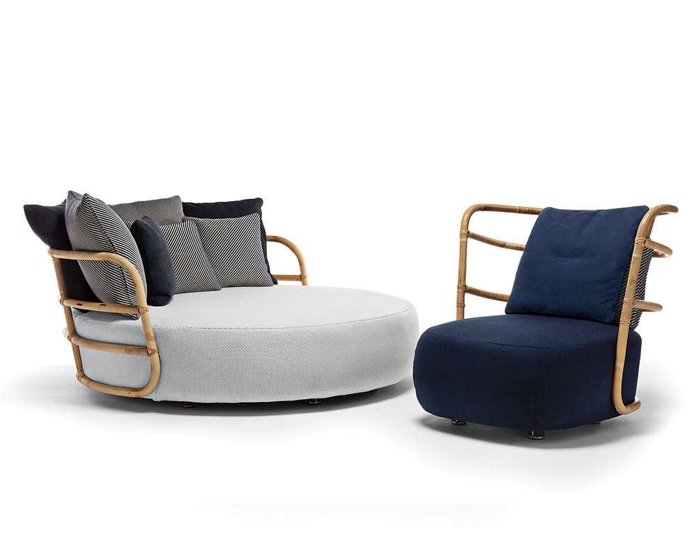 Jungle Armchair Slim upholstered in blue fabric and brown wooden structure on a white background.