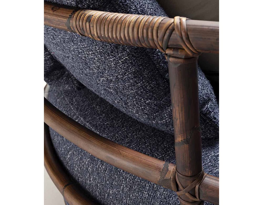 Closeup of Jungle Daybed upholstered in gray fabric and brown wooden structure.