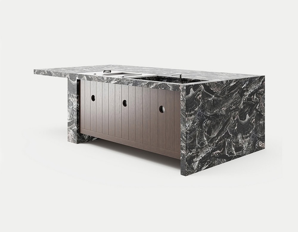 A Lapi Kitchen island with a dark, textured countertop and a light-colored cabinet with three drawers is shown at a slight angle against a white background