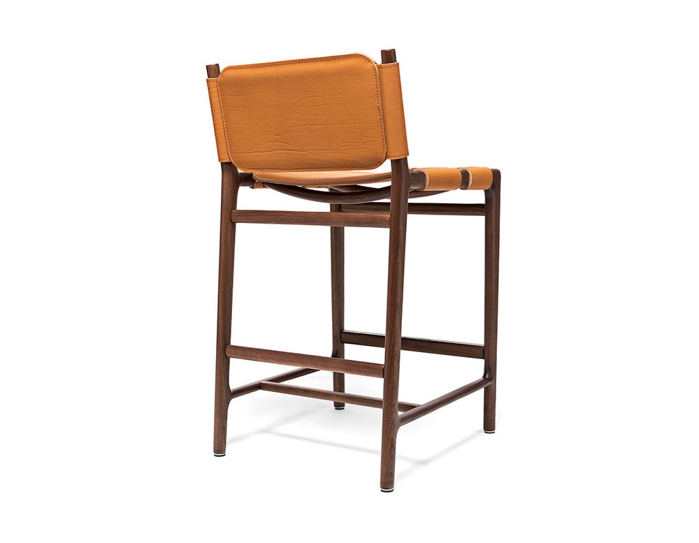Levante Stool. Structure in brown wood, seat and backrest in orange leather on a white background.