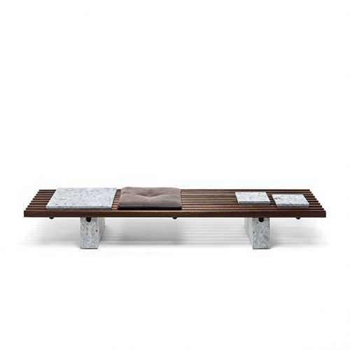 Panarea Coffee Table. Upper part made of brown wooden sticks and lower part is a block of gray stone on a white background.