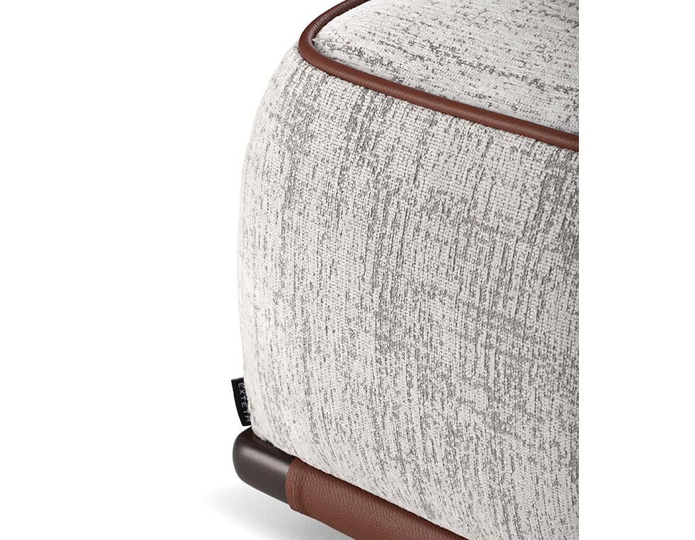 Closeup of Panarea Sofa in gray and brown fabric with backrest on a white background.
