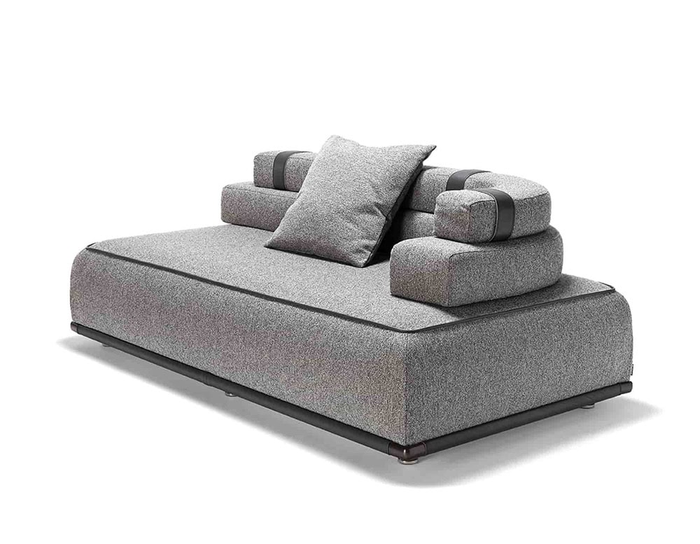 Panarea Sofa in gray fabric with backrest and cushions o a white background.