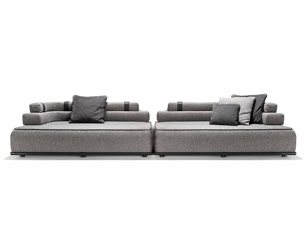 Two Panarea Sofas in gray fabric with backrest and cushions o a white background.