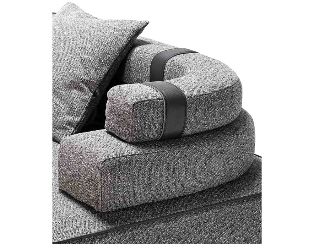 Closeup of Panarea Sofa in gray fabric with backrest and cushions o a white background.