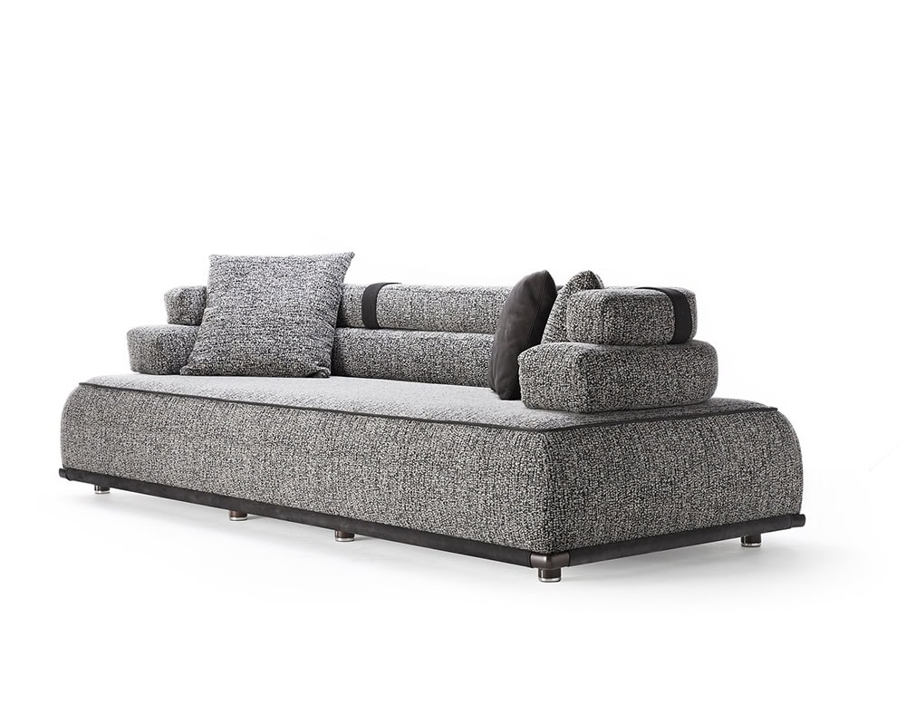 Panarea Sofa in gray fabric with backrest and cushions o a white background.