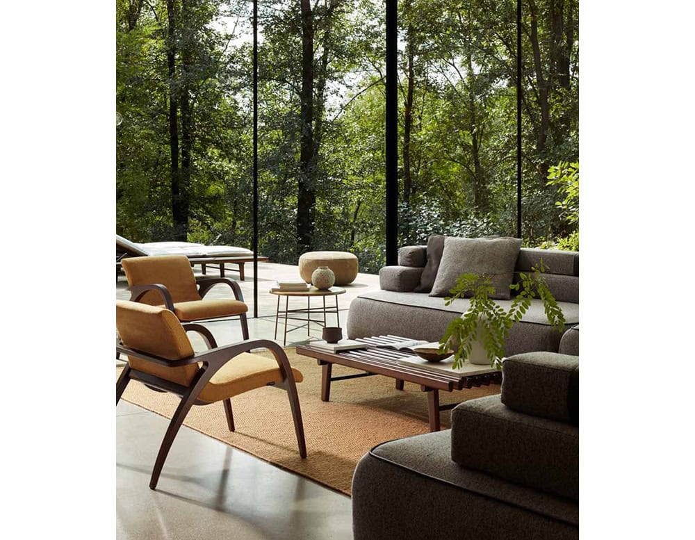 Closeup of Panarea Sofa in gray fabric with backrest and cushions in a living room.