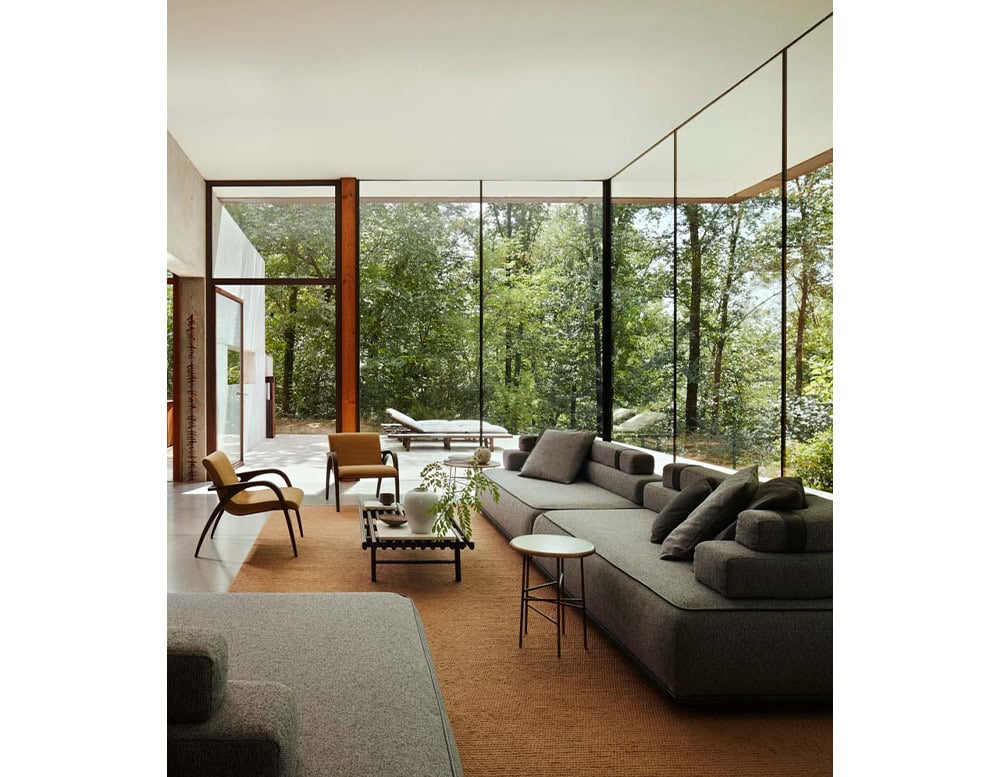 Two Panarea Sofa in gray fabric with backrest and cushions in a living room.