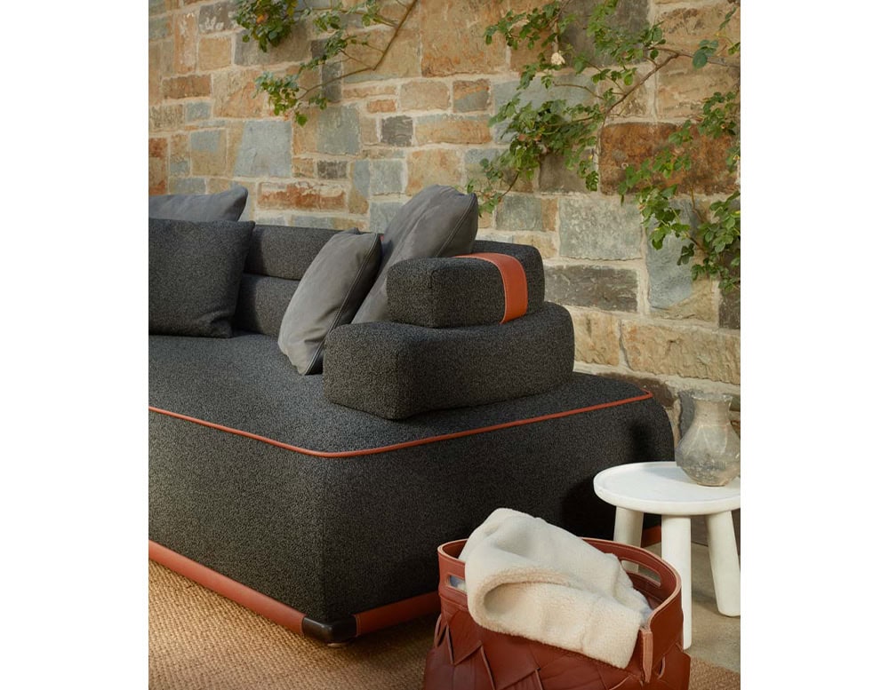 Panarea Sofa in gray and brown fabric with backrest in a living room.