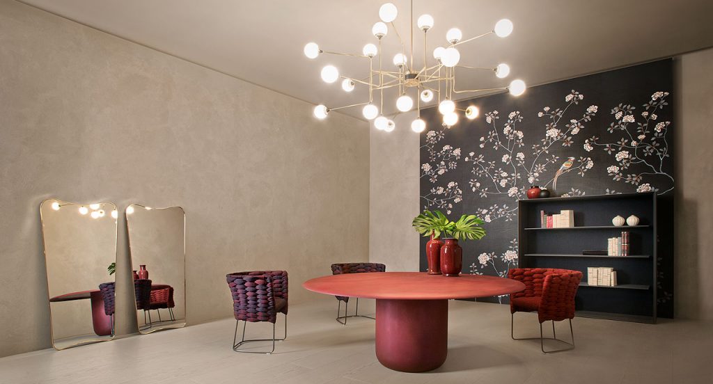 Three Ami Indoor Chairs, two red and black, one in red. Structure upholstery of woven fabric, seat cushion of fabric, structure and leg in steel in a dining room.