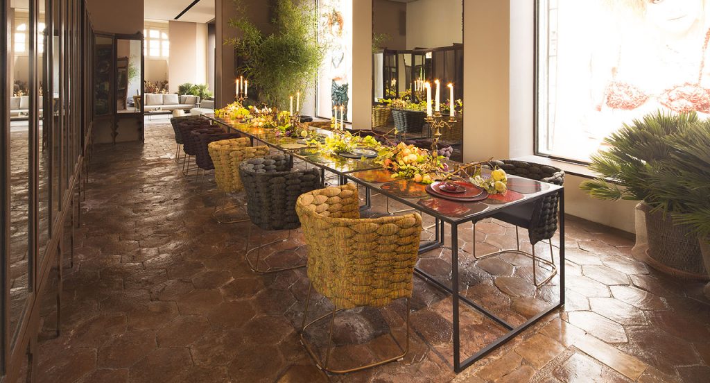 Eleven Ami Indoor Chairs, three in yellow, five in brown and three in grey. Structure upholstery of woven fabric, seat cushion of fabric, structure and leg in steel in a dining room.