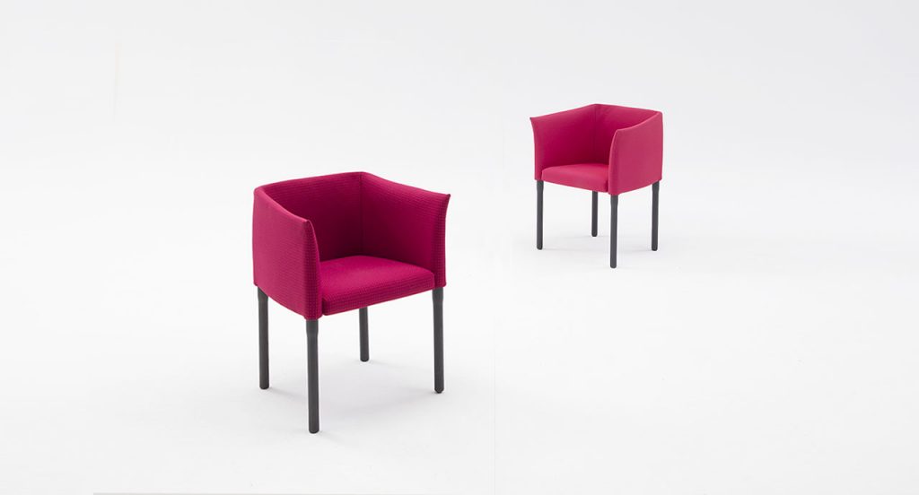 Two Elsie Chairs with armrest, upholstery in red fabrics, legs in natural heartwood on a white background.